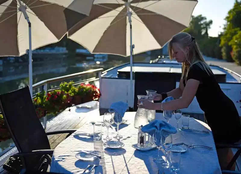 Your hostess setting the table
